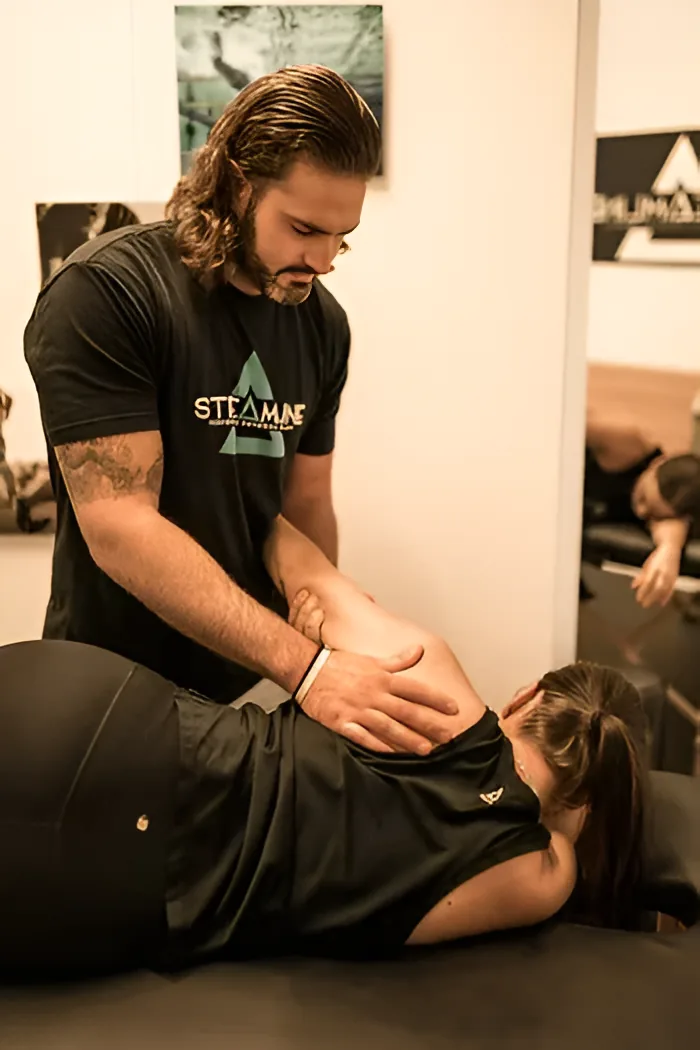A clinician applying a low back mobilization at Streamline Performance Physical Therapy in Phoenix, AZ